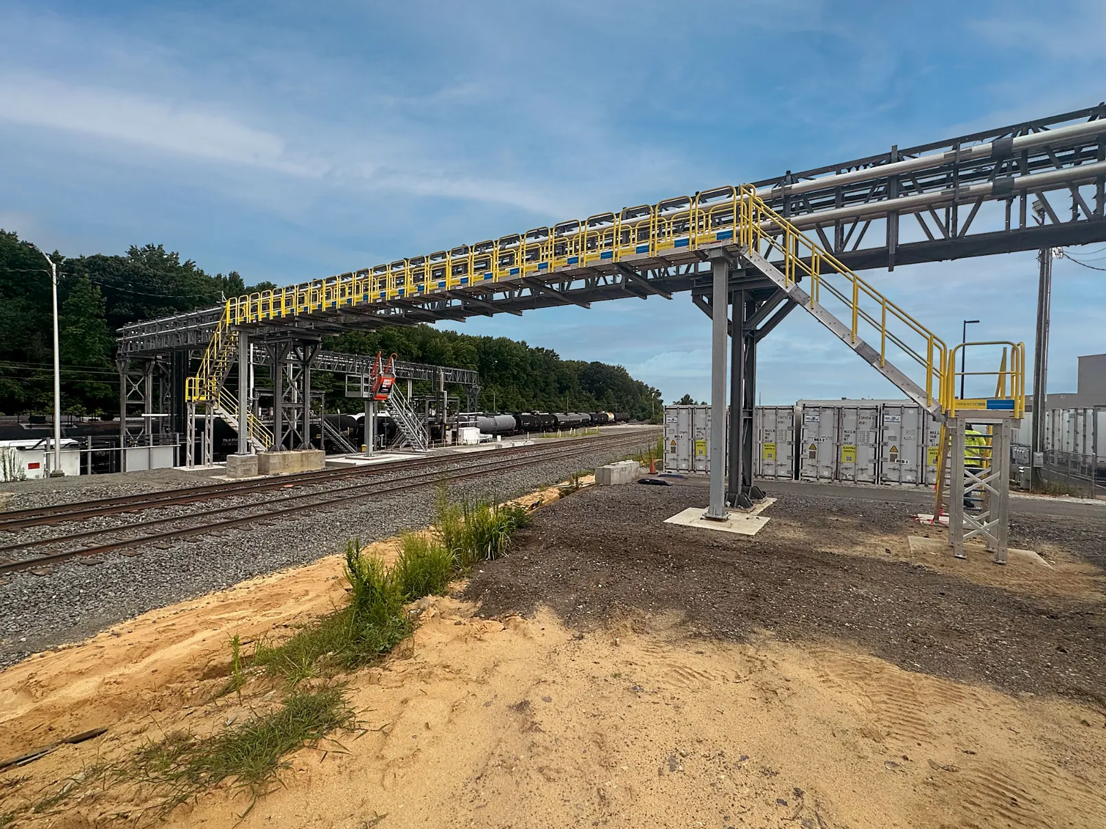 ErectaStep-loading-terminal-metal-bridge-over-rail-tracks-