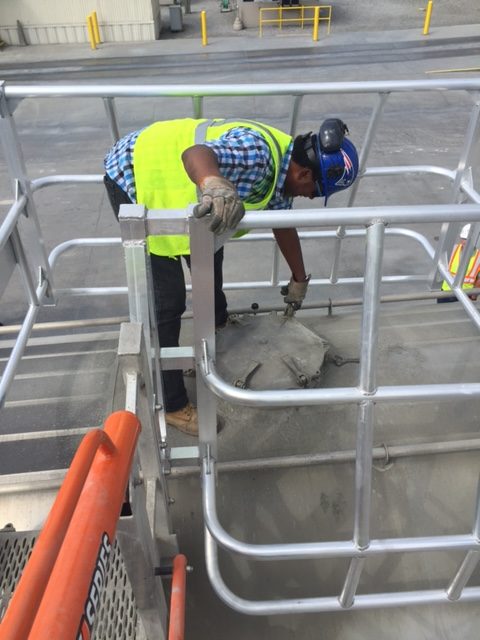 Offset safety cage for safe cement loading